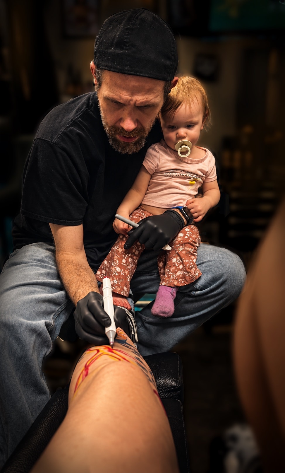 Aurora wearing an Assistant to the Tattoo Artist shirt